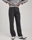 woman wearing grey tailored pants wth center pleat