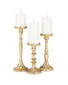three gold candle holders with pillar candles in 3 different sizes: small, medium and large