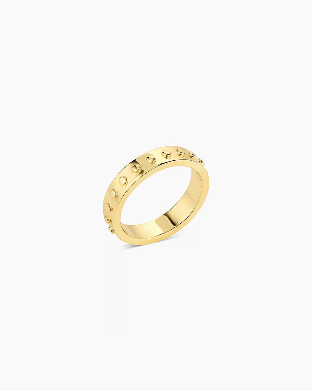 A gold-plated band ring with metallic gold studs and a textured surface.