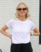Woman wearing a white linen t-shirt