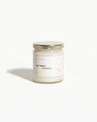 Candle jar labeled 'First Snow + Evergreen' 