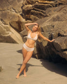 Woman wearing a beige triangle bra and beige hipster boyshort underwear made from tencel