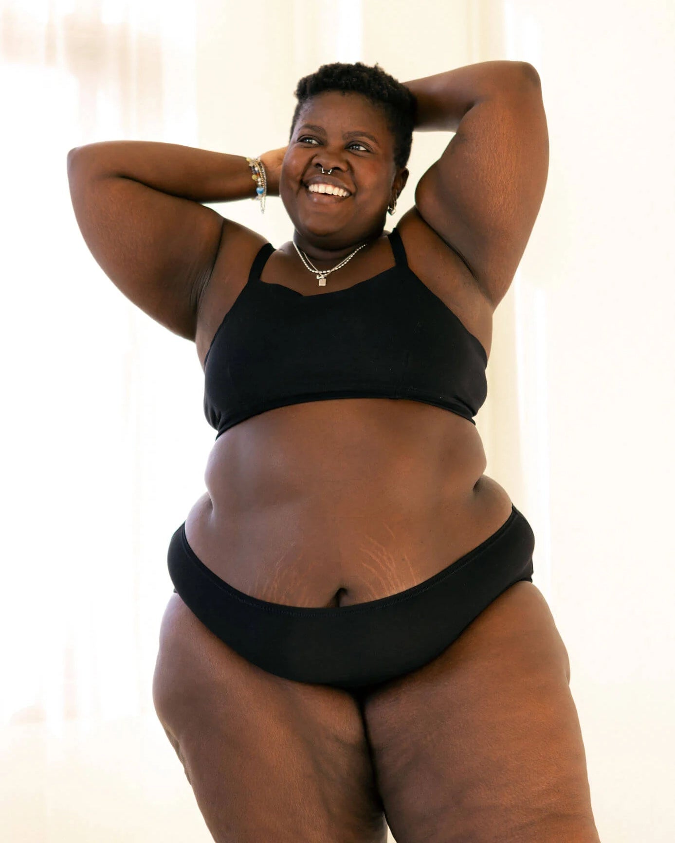 woman wearing black hipster boyshort underwear and matching triangle bra