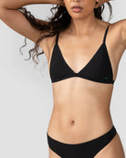 a woman wears a Black string triangle bralette with thin straps by Huha
