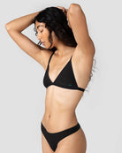 a woman wears a black string triangle bralette with thin straps by Huha