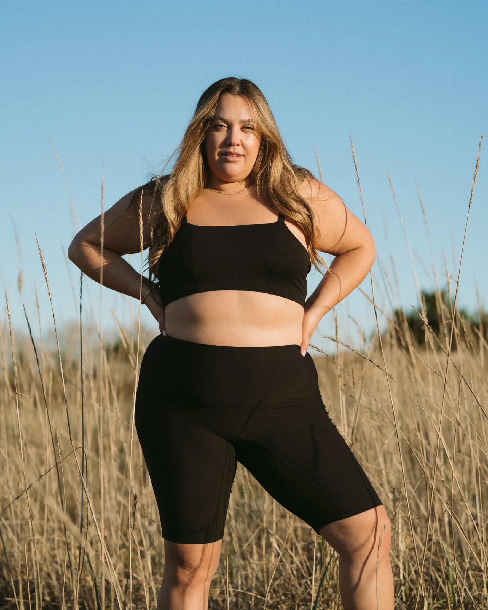 Woman in a black bandeau sports modal bralette and shorts