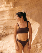 Woman in a brown bandeau sports modal bralette and undies