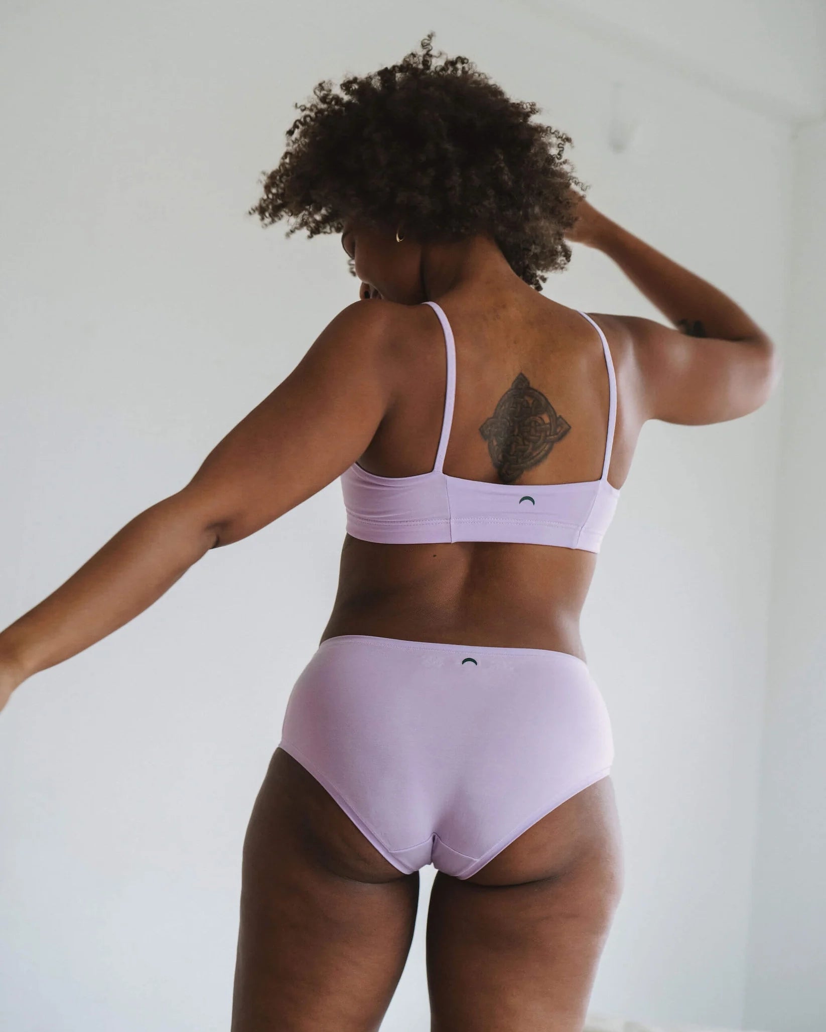 Woman in a light purple bandeau sports modal bralette and matching undies