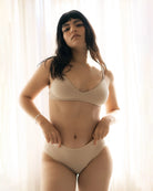 woman wearing a beige triangle bralatte and matching undies