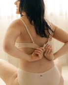 woman wearing a beige triangle bralatte and matching undies