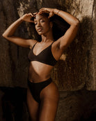 woman wearing black triangle wireless bra and undies in black modal fabric by Huha