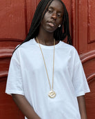 tan cord necklace with a chunky silver pendant 