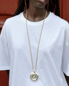 tan cord necklace with a chunky silver pendant 