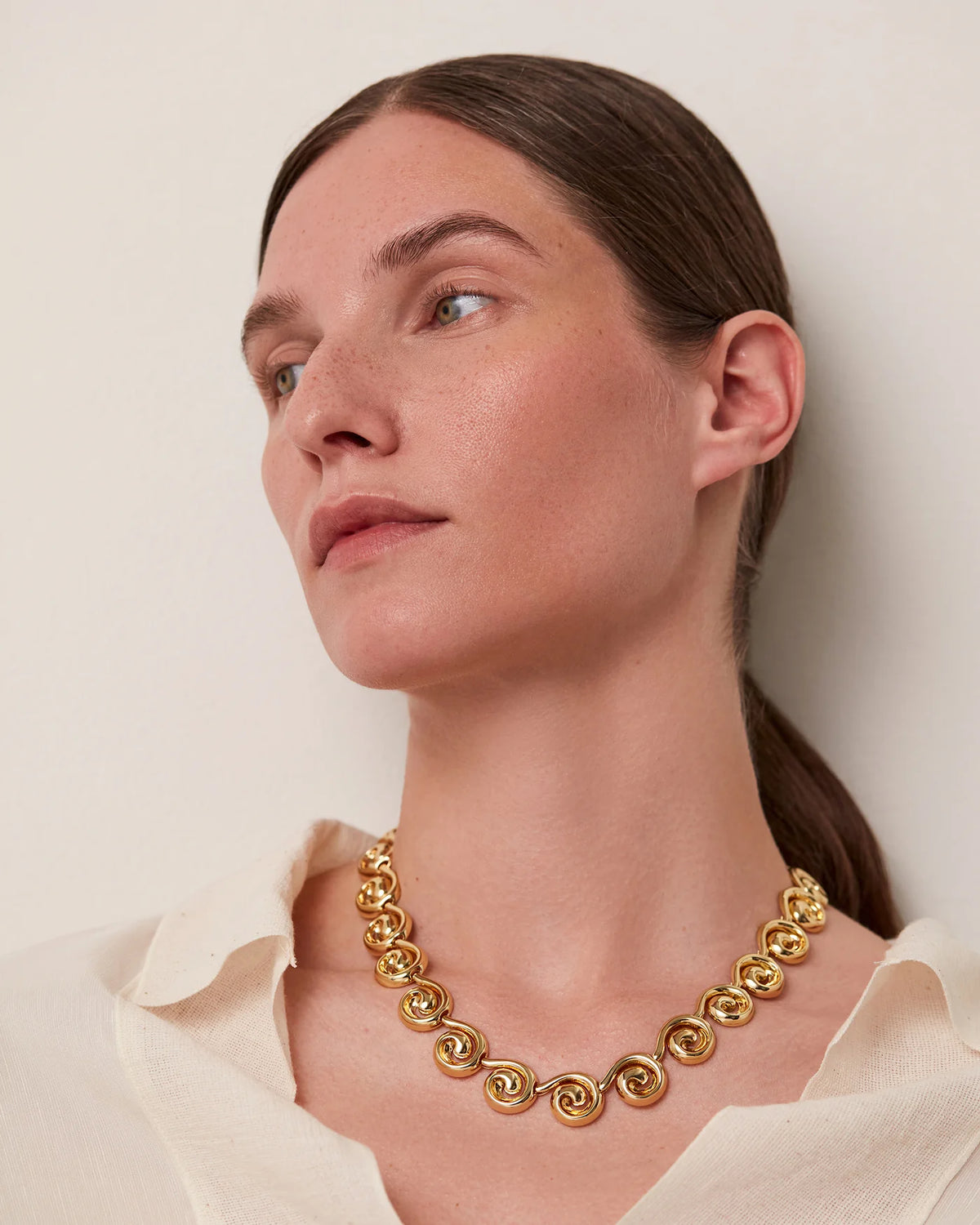 gold swirl statement necklace