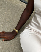 chunky statement gold bracelet with swirl details