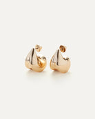 a pair of gold statement earrings by Jenny Bird