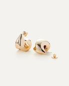 a pair of gold statement earrings by Jenny Bird
