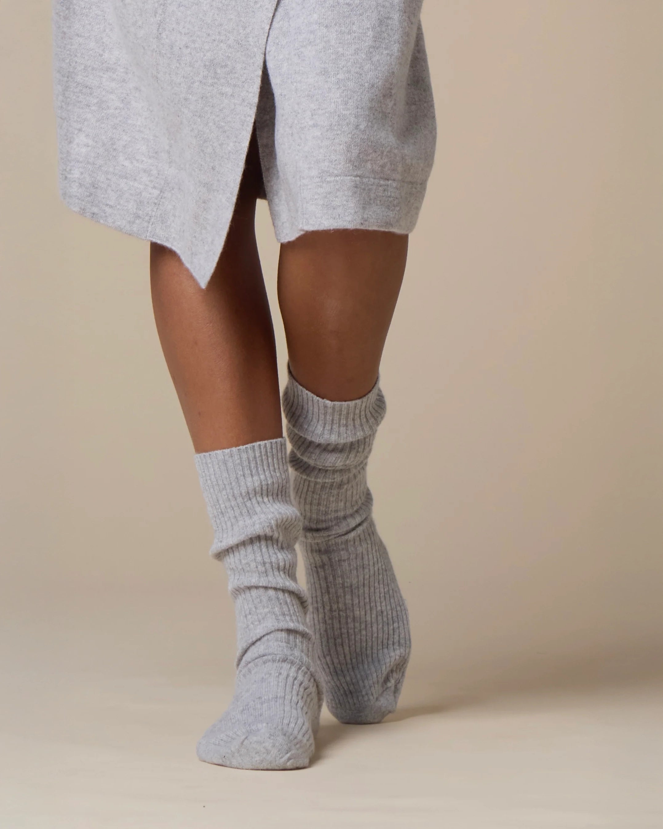 feet wearing cashmere merino sleep socks in grey
