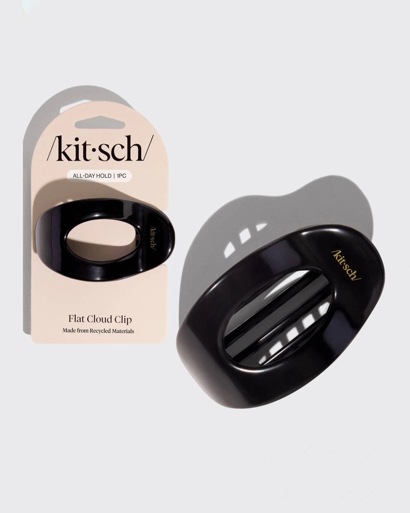 Black hair clip with 'kitsch' branding