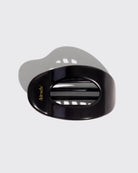 a black hair clip with 'kitsch' branding