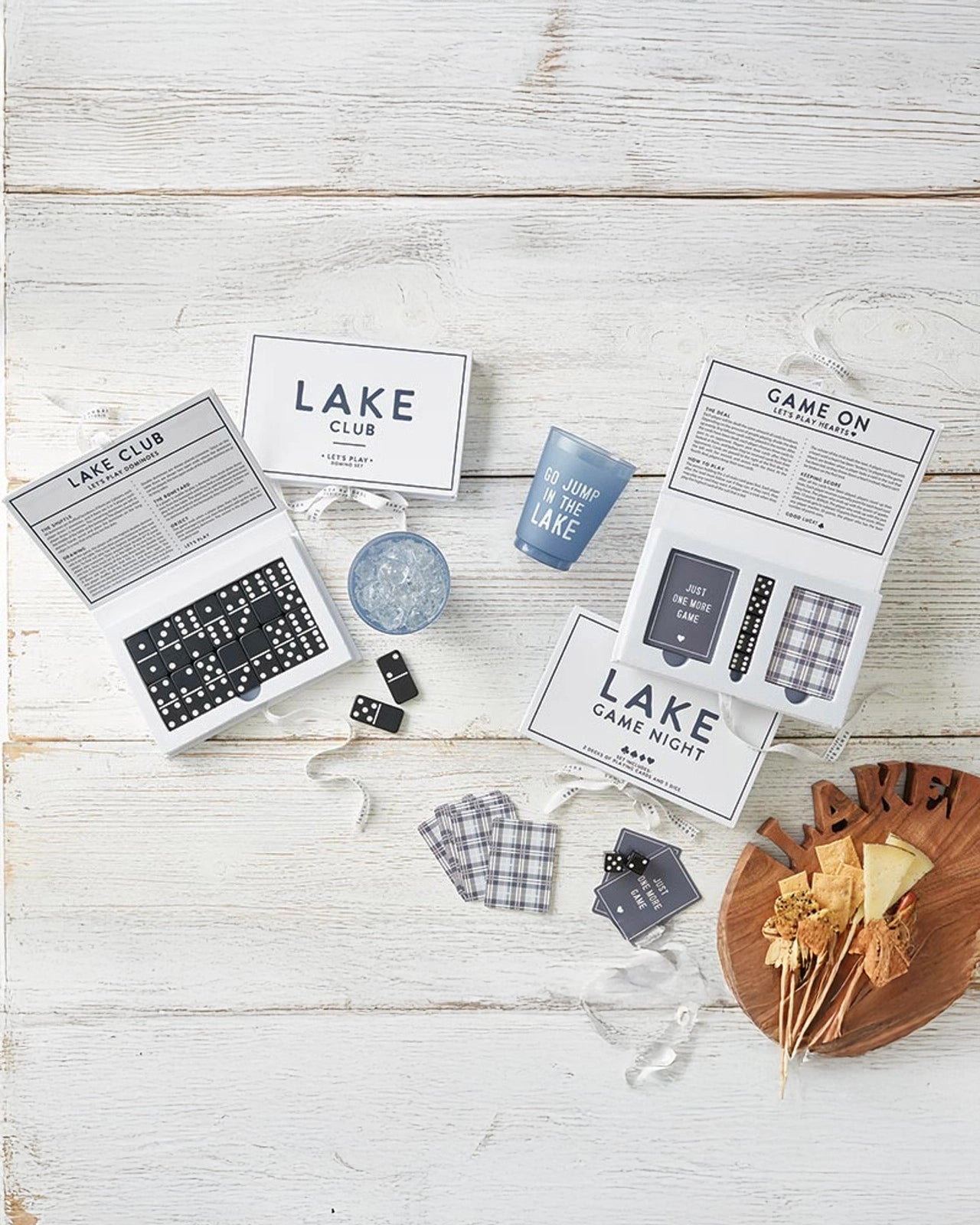 A spread of different games including playing card game set called 'Lake Game Night' that shows rules and the 2 sets of cards and 4 dice included