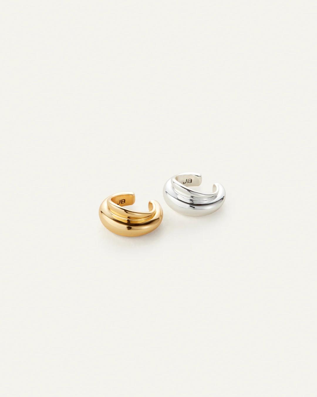 two ear cuffs one in silver and the other in gold