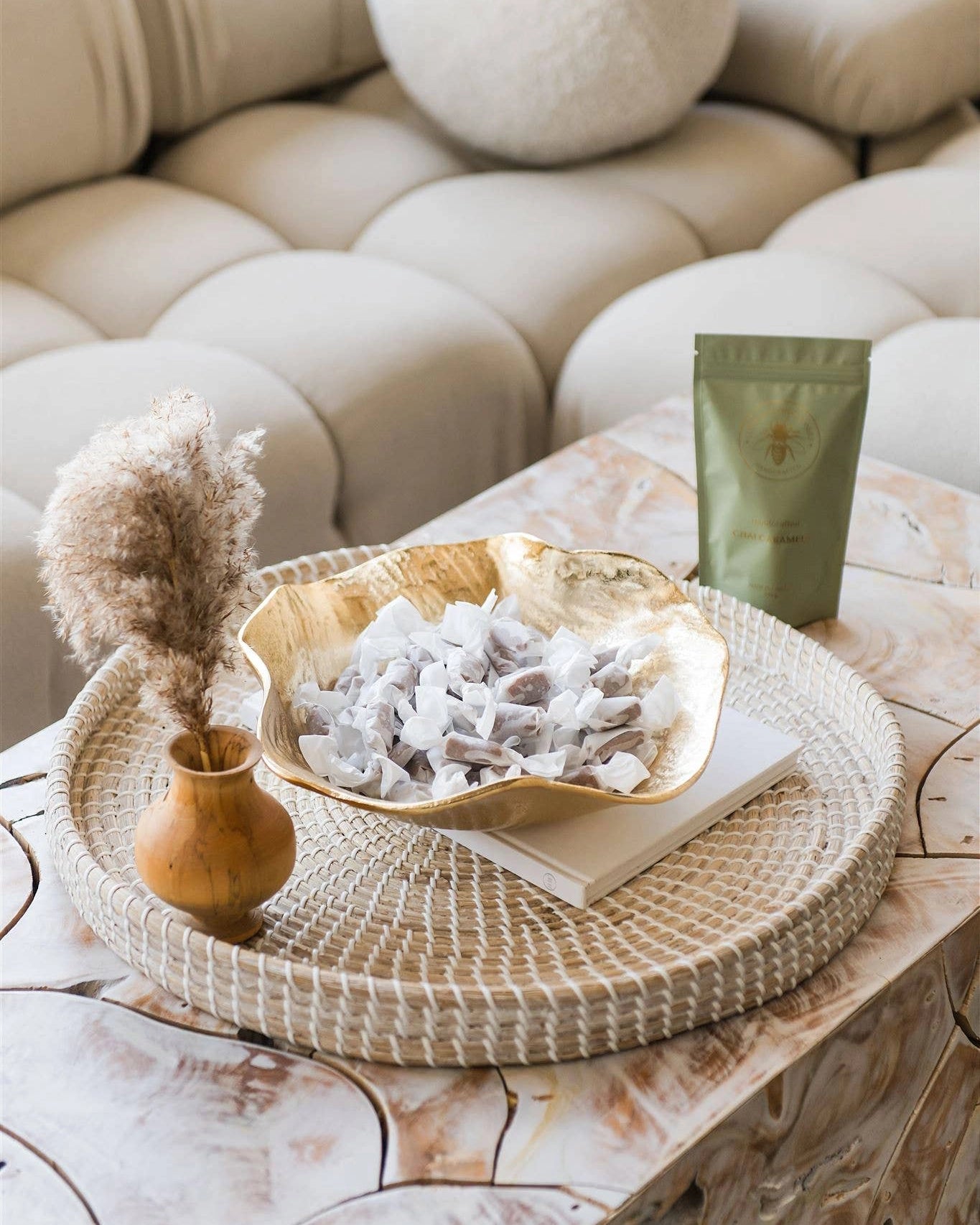 A bowl of caramels and a green bag of chai caramels by Little B Confectionary caramels
