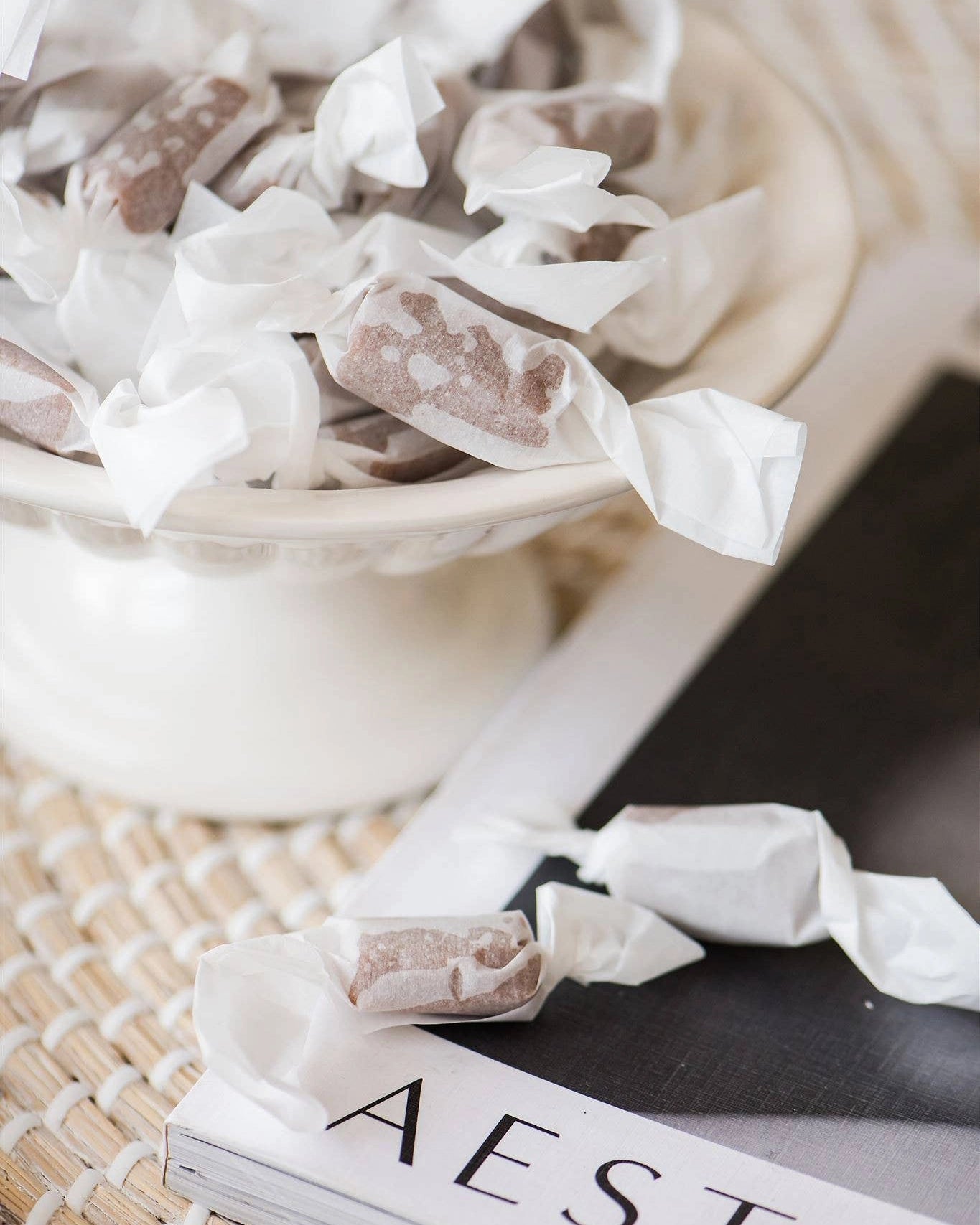 Caramel candies in a white bowl