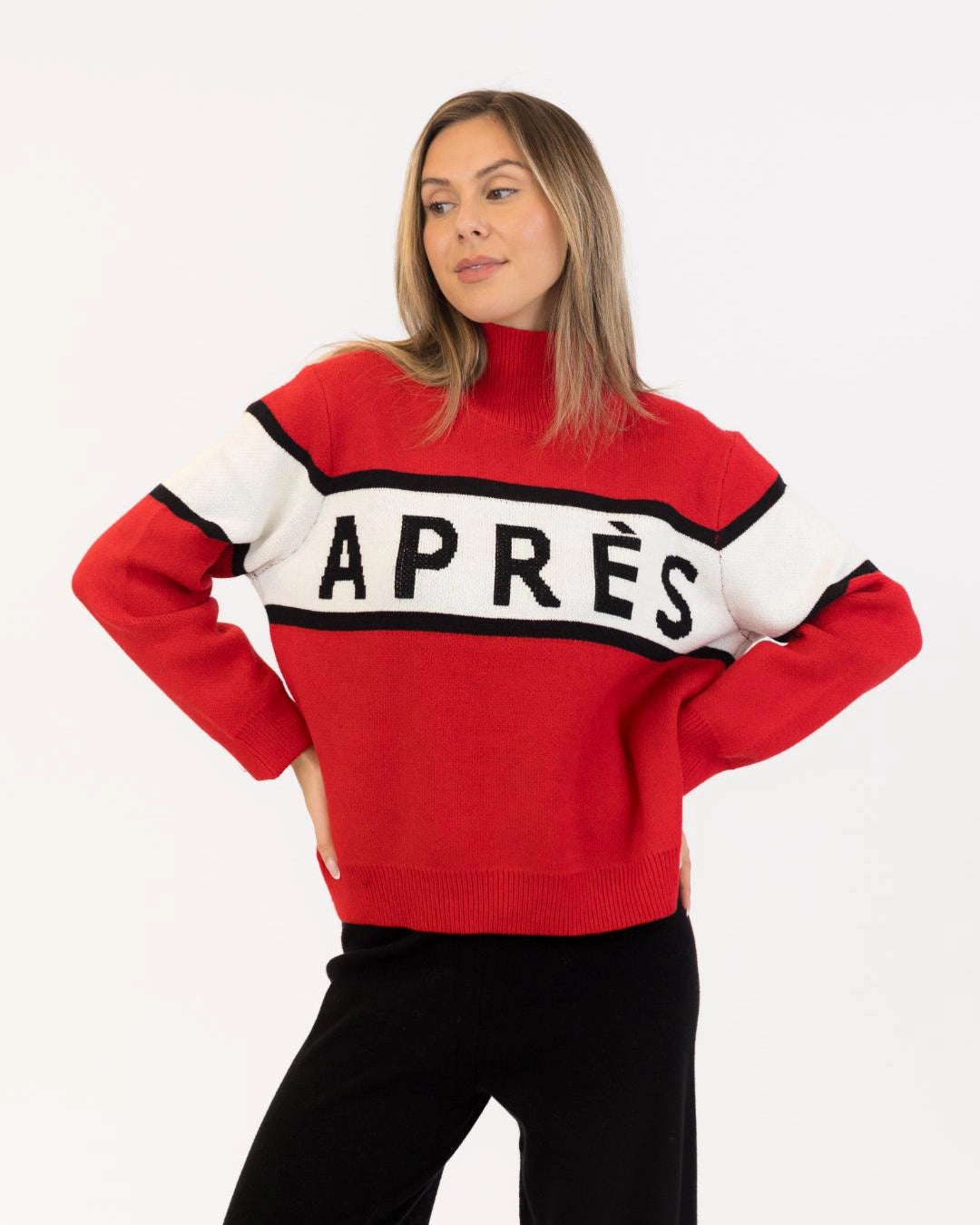 Woman wearing a red sweater with black and white accents with 'Après' on it