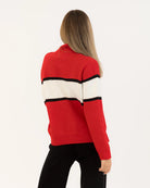 woman wearing a red sweater with white and black accents and 'apres' on the chest