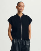 a woman wears a black tee zip up sweater  tee