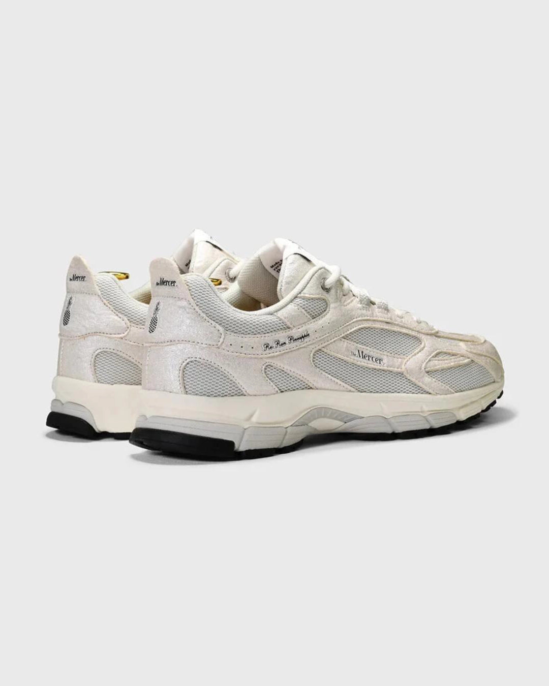 white sneakers with mercer branding on the side