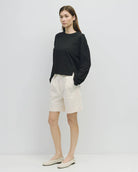 woman wearing white wide leg chino shorts