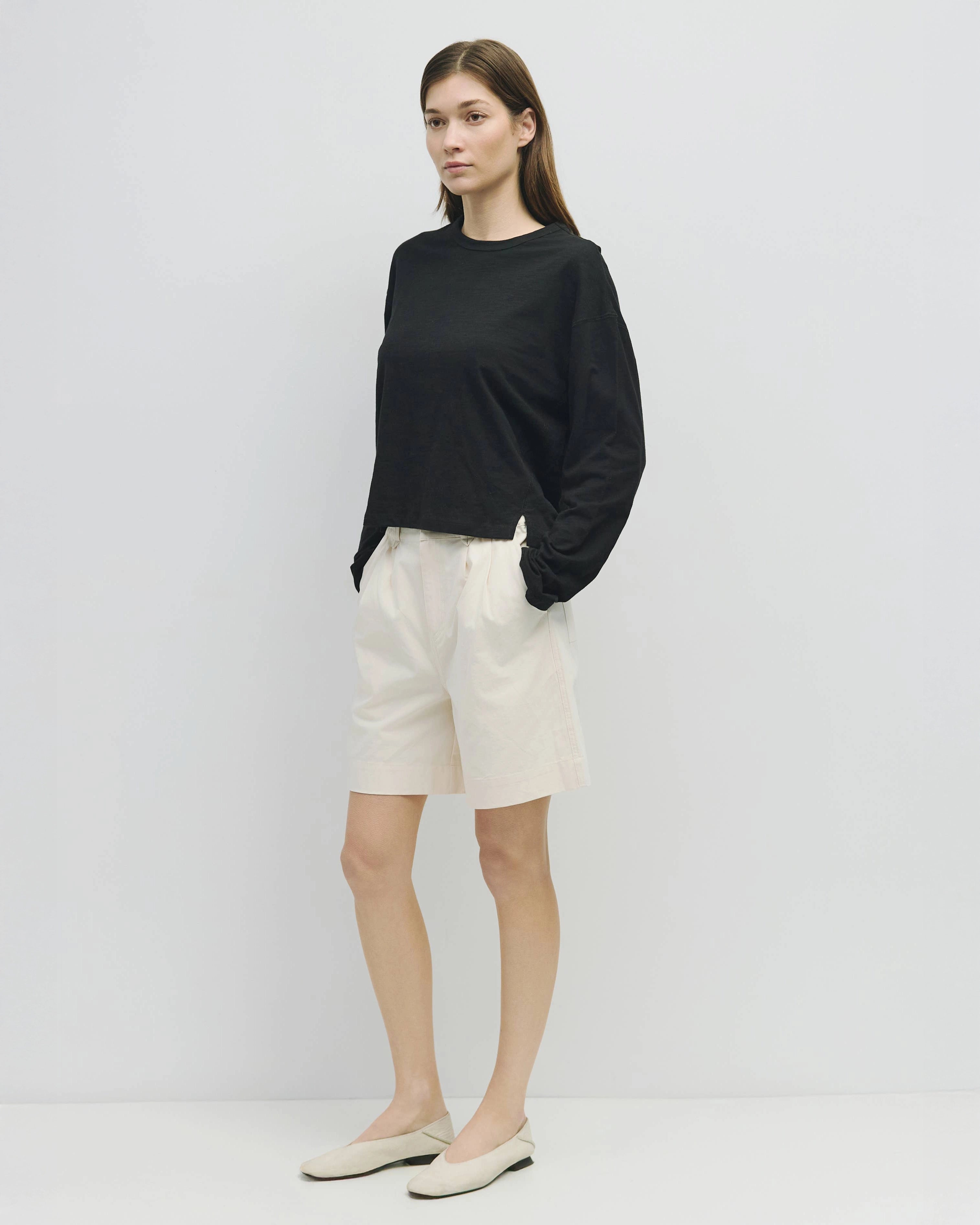woman wearing white wide leg chino shorts
