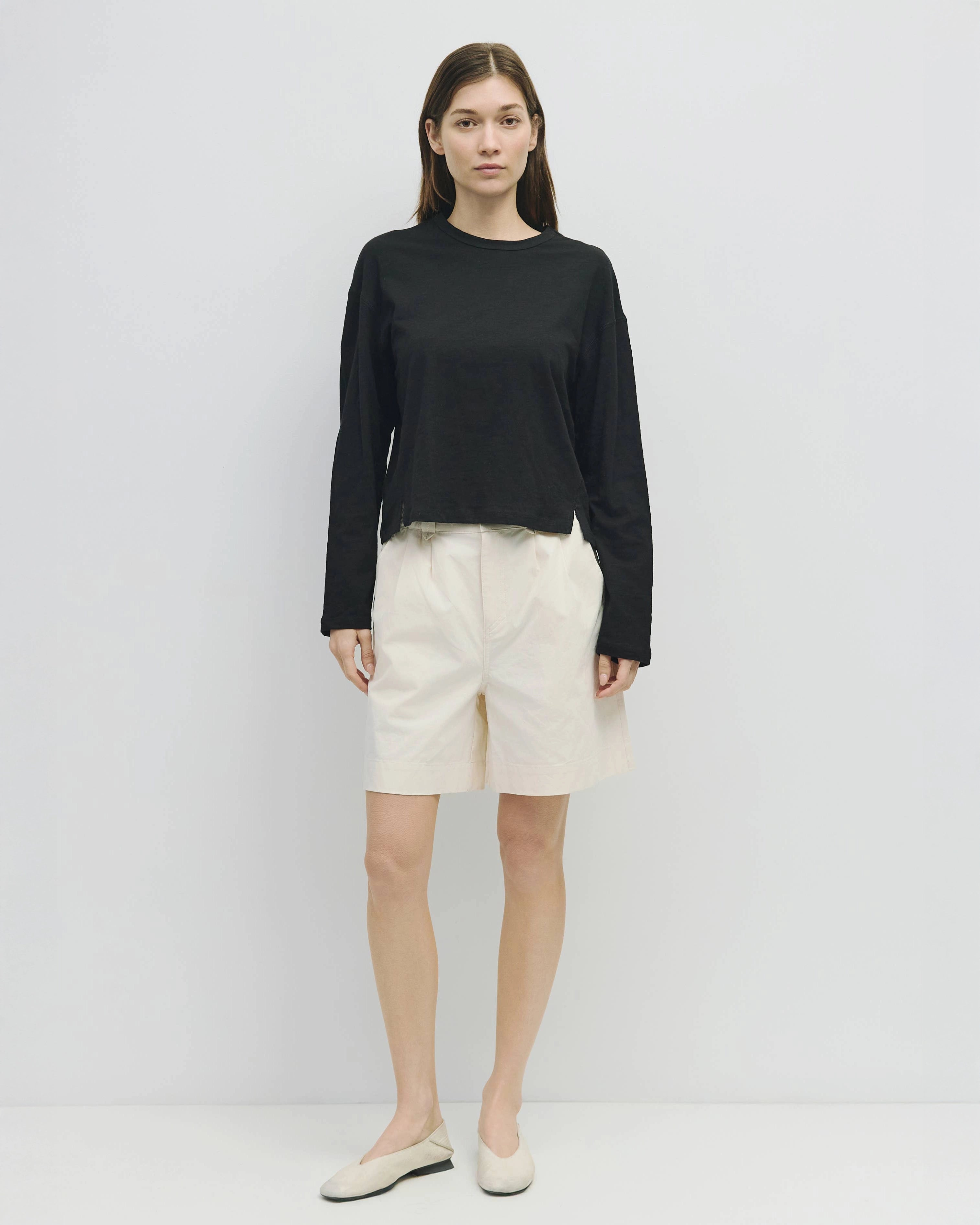 woman wearing white wide leg chino shorts