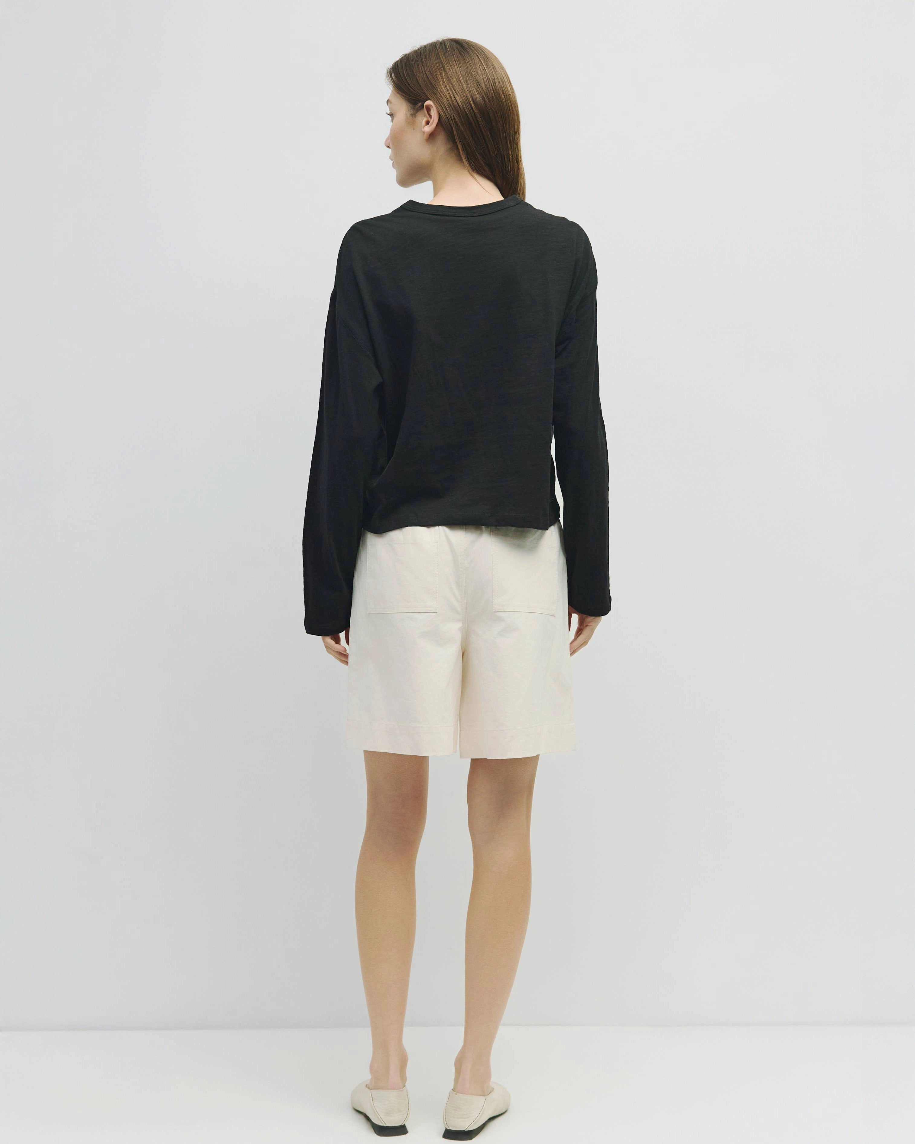 woman wearing white wide leg chino shorts