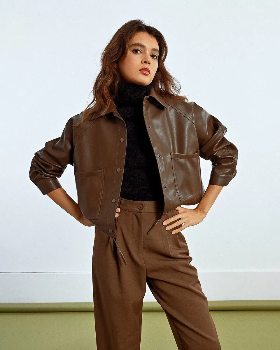 Woman wearing a brown leather jacket 