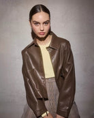 Woman wearing a brown leather jacket 