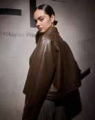 Woman wearing a brown leather jacket 