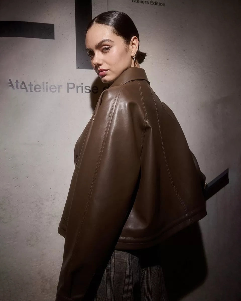 Woman wearing a brown leather jacket 