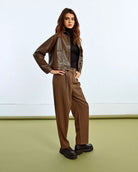 Woman wearing a brown leather jacket 