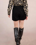 Woman wearing black high waisted shorts