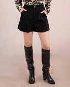 Woman wearing black high waisted shorts