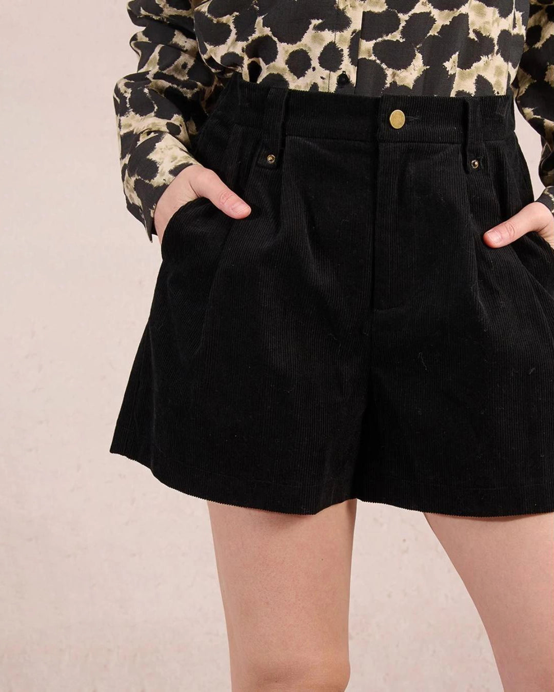 Woman wearing black high waisted shorts