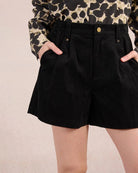 Woman wearing black high waisted shorts