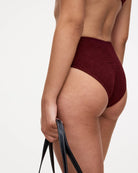 A knitted ribbed material bikini bottom in burgundy colour by OAS