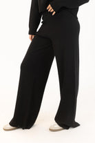 side view of a black knit wide leg pant