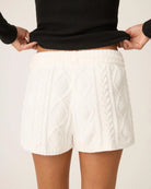 a woman wears white cable knit chenille loungewear shorts by PJ Salvage