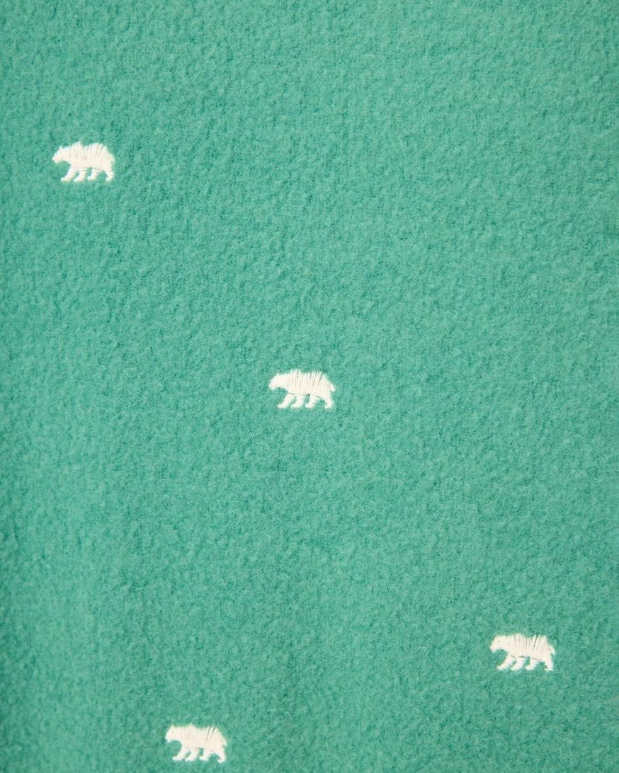 green fabric with white bears embroidered all over