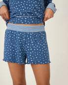 A woman wearing blue polka dot floral shorts